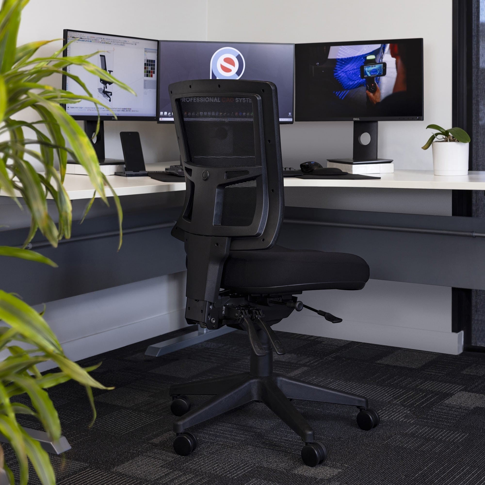 Rear view of the breathable mesh back on the Buro Metro II chair at a commercial workstation.
