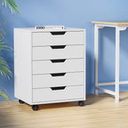 White Studio mobile under-desk storage cabinet positioned in a modern, bright home office setup.