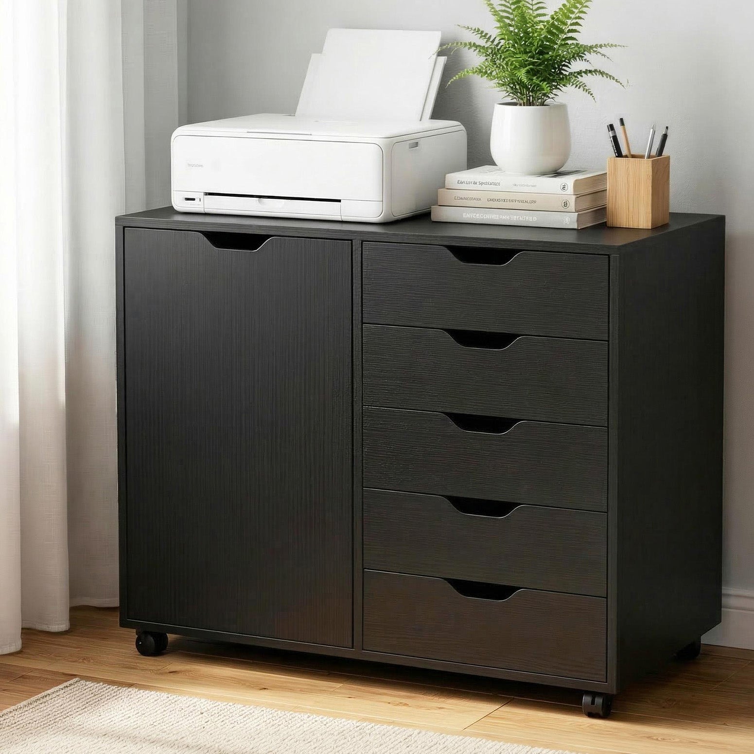 Black Studio Executive storage console anchoring a modern professional home office setup.