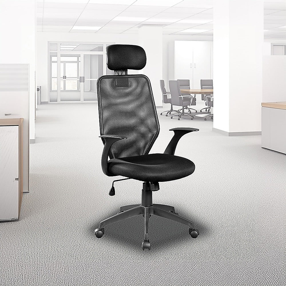 Black Studio V63 performance desk chair set up in a bright, modern professional office workspace.
