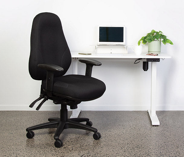 Cloud Office Studio Buro Persona 24/7 heavy-duty ergonomic chair in black fabric at a white standing desk.