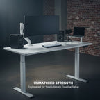 Cloud Office Studio Pro 140cm white standing desk with dual motors, monitor arm, speakers, and laptop.
