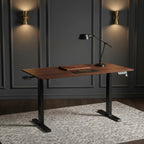 Cloud Office Studio walnut standing desk with black industrial frame, digital control panel, and desk accessories.