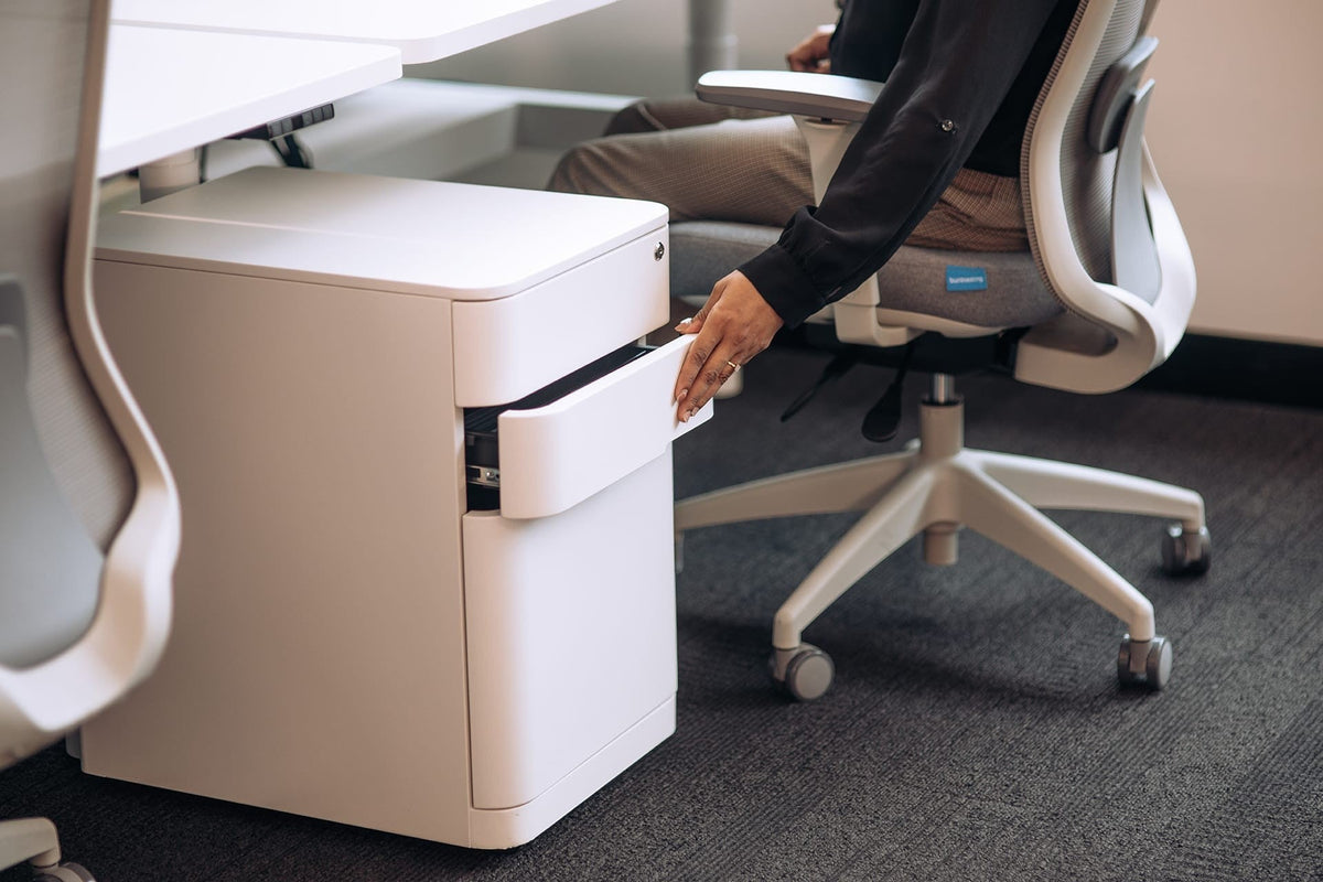 Cloud Office Studio Buro MyWorkSpace white 3-drawer mobile steel pedestal being opened by a person in an office